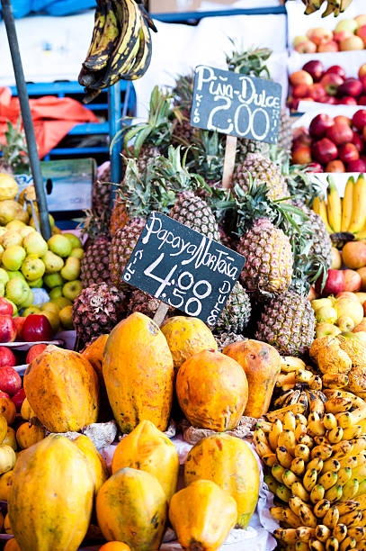 Photography of pineapple on market stall 
