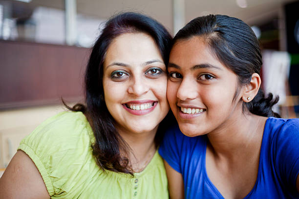 istock Cheerful Indian Mother and Daughter sitting at Cafeteria 175232830