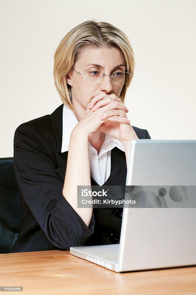 Pensive working woman "Portrait of an pensive businesswoman working on the laptop. Vertical framing, adobe rgb photo." 30-39 Years Stock Photo