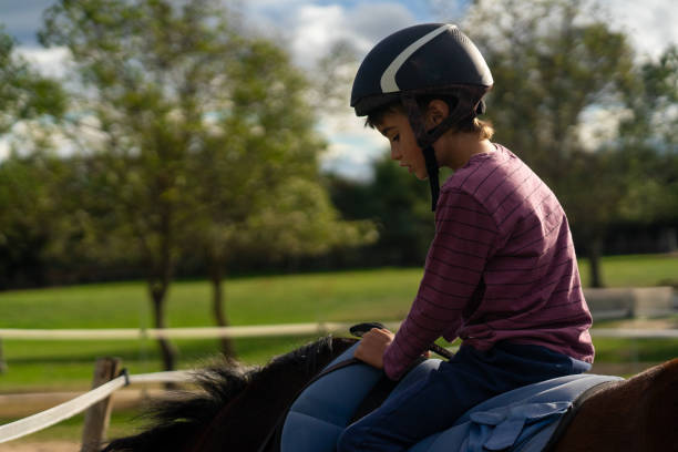 istock Child learning to ride a horse 1752331208