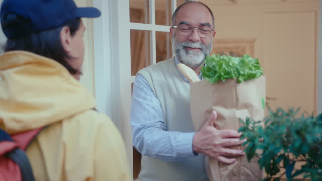 Elderly Man Receiving Online Order from Supermarket