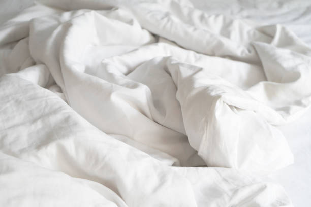 istock Unmade bed; wrinkled pillowcases, bed sheet and duvet 1752337231