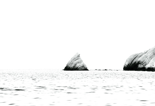 Black and white photo of the Scoglio della Vela in front of the beach of Portonovo (Marche, Italy).