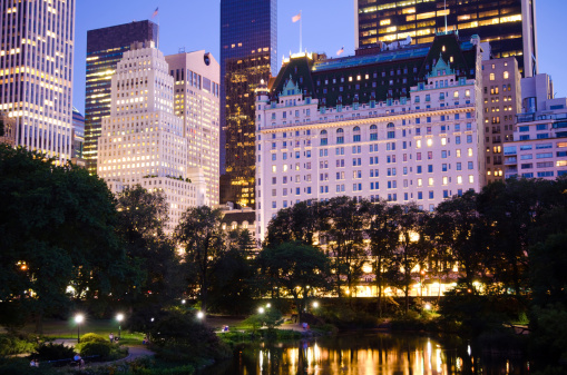 Plaza Hotel and other buildings as seen from Central Park at night in New York City.