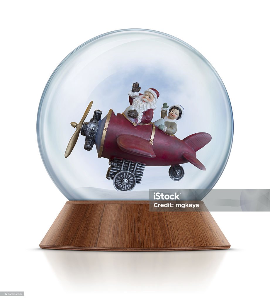 Santa with Plane in Snow Globe Santa Claus and little boy flying with airplane and waving in the snow globe. Clean image and isolated on white background. Snow Globe Stock Photo