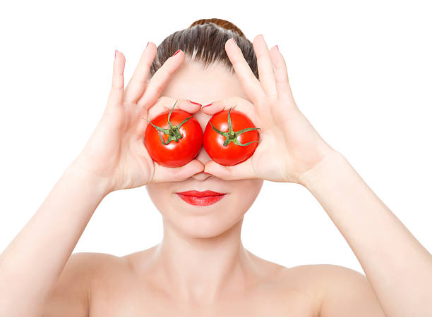 istock Pretty woman with tomato on white background 175234541
