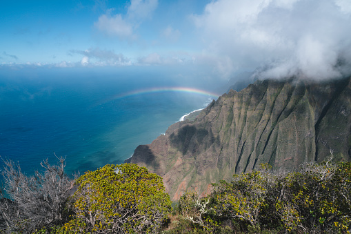 Rainbow over Na Pali coast in Kauai Hawaii island USA