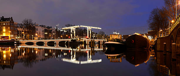 istock Illuminated Magere Bridge in Amsterdam over reflective water 175235042