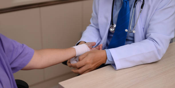 istock Doctor wrapping gauze around patient's wrist 1752352139