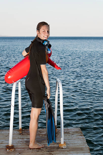istock Free diver with red safety buoy 175235271
