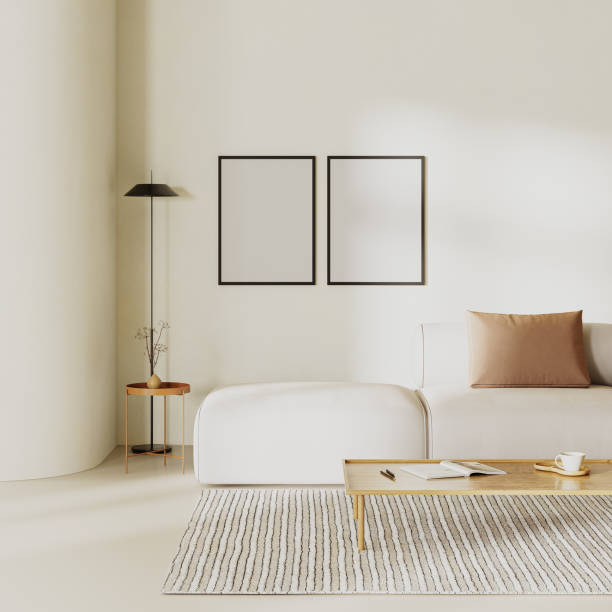 istock Blank poster frames in minimalist living room interior with curvy wall, sofa with pillows and beige plasters walls,. Interior mockup, 3d render 1752353347