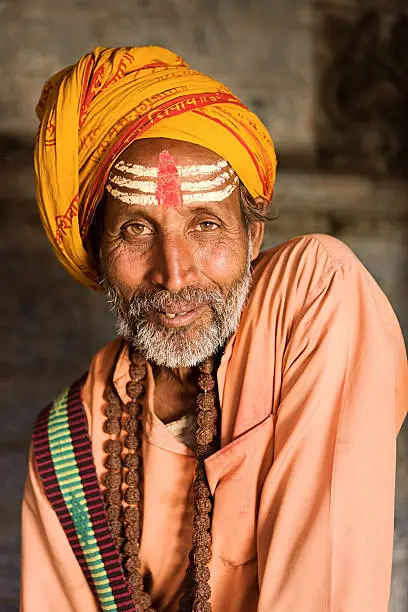 "In Hinduism, sadhu, or shadhu is a common term for a mystic, an ascetic, practitioner of yoga (yogi) and/or wandering monks. The sadhu is solely dedicated to achieving the fourth and final Hindu goal of life, moksha (liberation), through meditation and contemplation of Brahman. Sadhus often wear ochre-colored clothing, symbolizing renunciation."