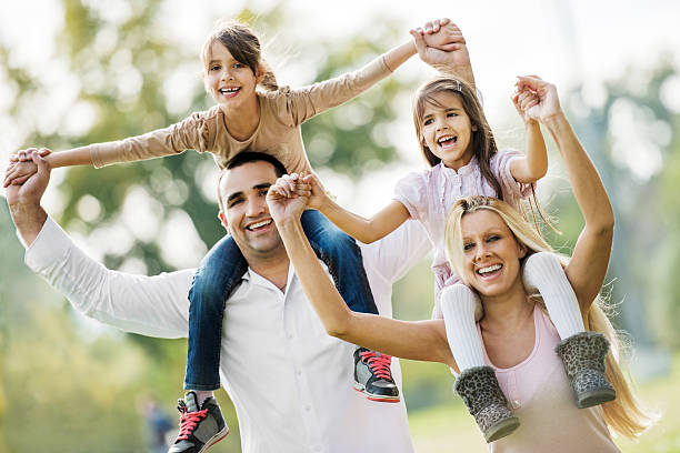 istock Mother and father piggybacking their daughters. 175235844