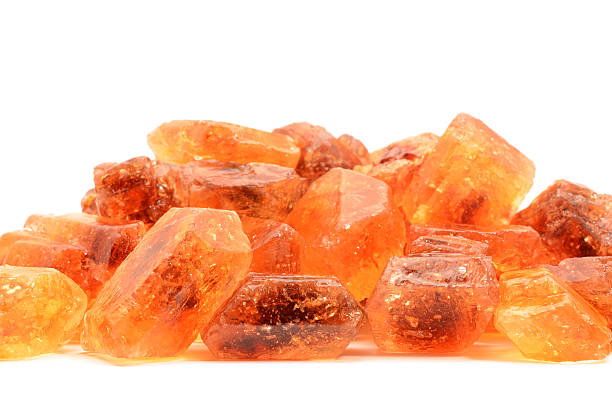 istock Heap of brown rock sugar on white background 175236187