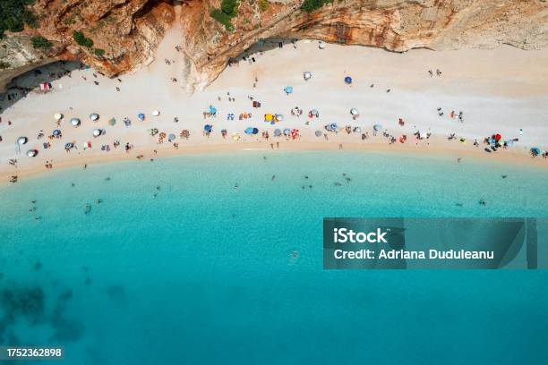 Aerial View Of People On Beautiful Beach By Mountain In Lefkada Greece Stock Photo - Download Image Now
