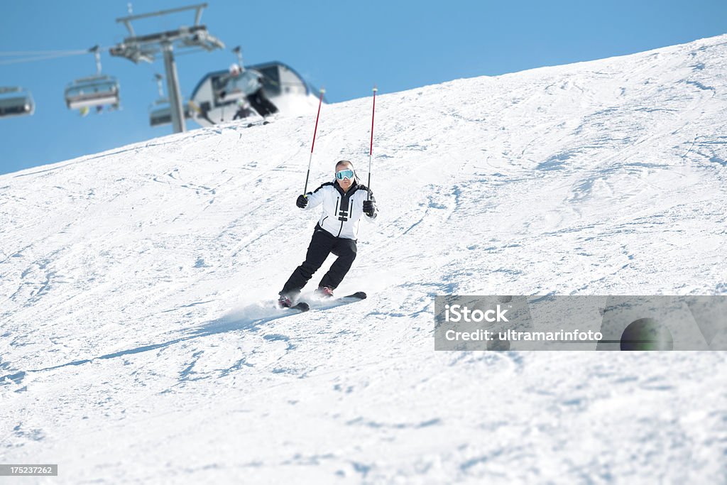 Ski instructor showing an exercise for carvnig skiing Ski instructor showing a position of legs. Skiing class. Adult Stock Photo