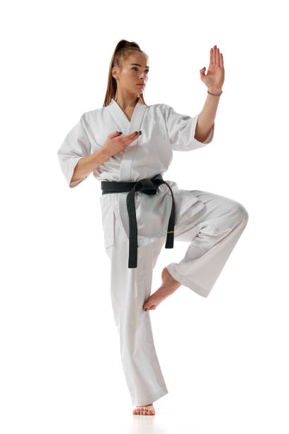 istock Balance. Master black belt Tae Kwon Do teacher in uniform standing on one leg isolated over white background. 1752373620