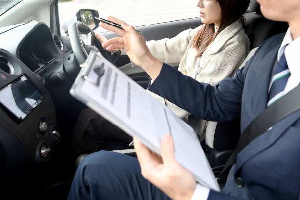 A woman and a male instructor during driving lessons