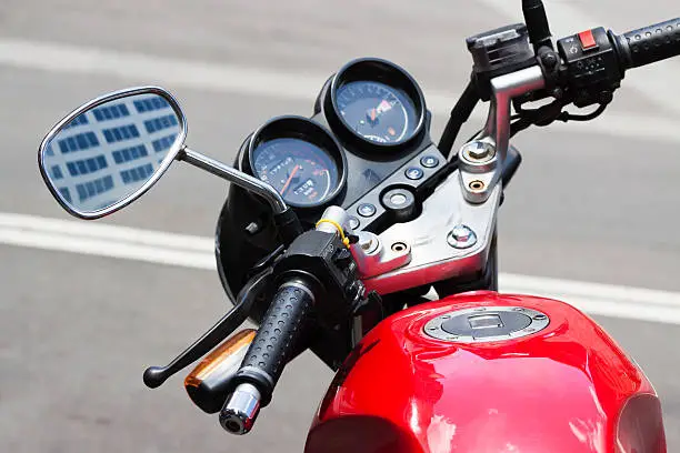 Photo of Closeup motorcycle handlebars and reversing mirror, copy space