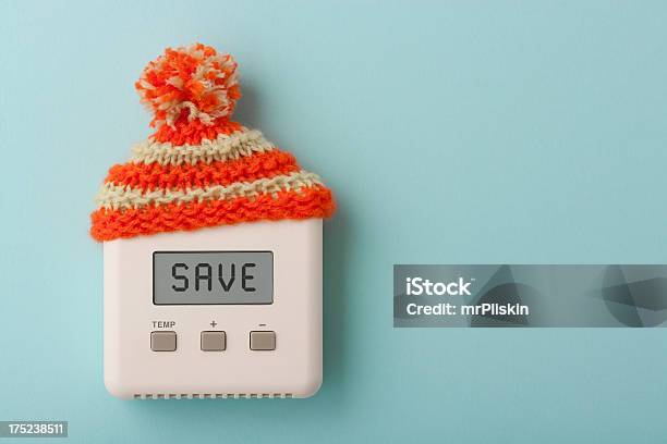 Save On Digital Room Thermostat With Wooly Hat Stock Photo - Download Image Now - Heat - Temperature, Thermostat, Home Interior
