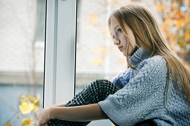 istock Rainy Day: Girl Sitting on the  Window 175239031
