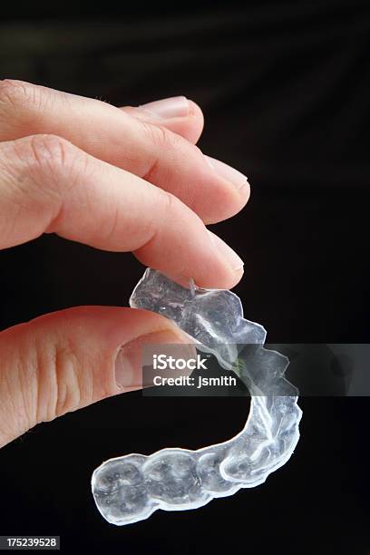 Dispositivos De Dental En Los Dedos Sobre Fondo Oscuro Foto de stock y más banco de imágenes de Ortodoncia invisible