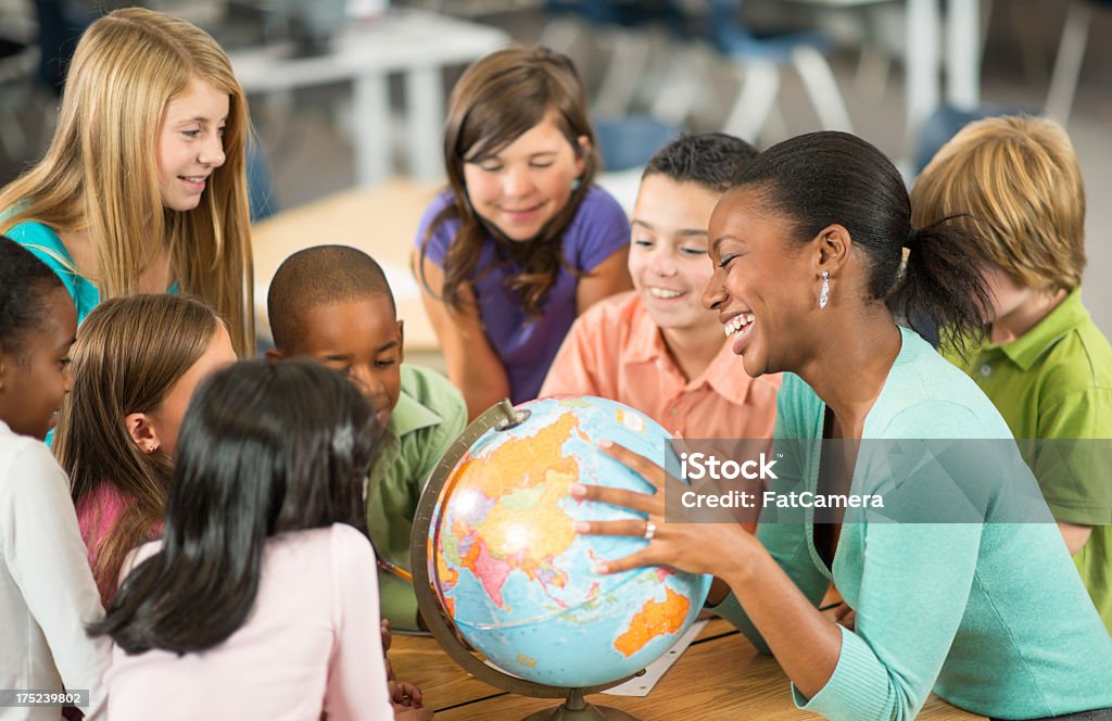 Classroom A diverse group of children in their classroom. Globe - Navigational Equipment Stock Photo