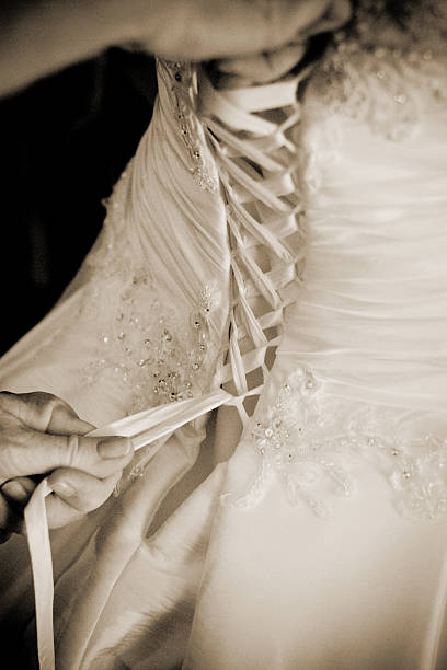 istock Bride Preparing for Wedding as her Dress is Laced up 175239893