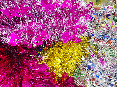 Festive background. Lots of multicolored tinsel close-up..