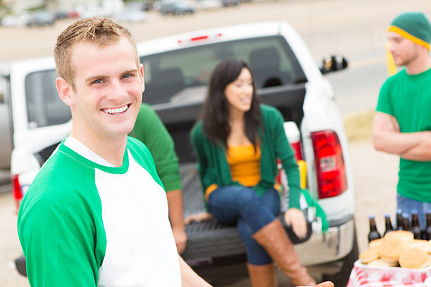 istock Happy young man at an outdoor sporting tailgate party 175240426