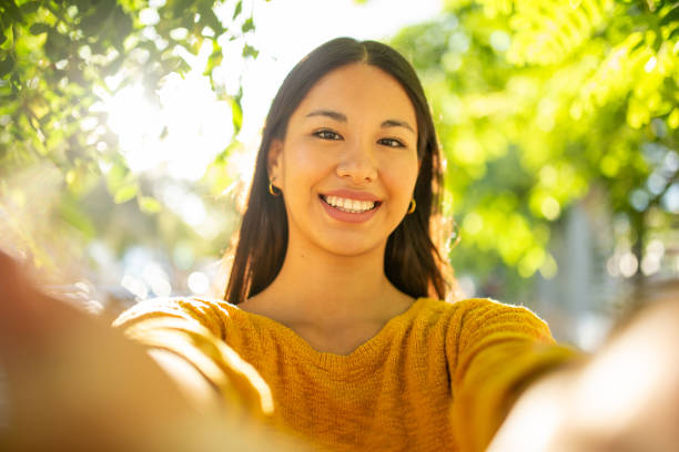 istock happy young woman taking selfie in park 1752409427