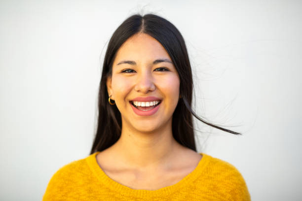 istock Close up beautiful laughing young woman by white wall 1752411064