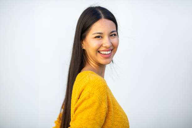 istock Profile of smiling young woman by white background 1752411588