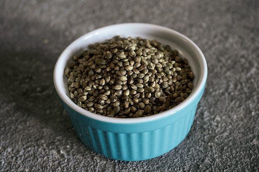 Hemp grains in a bowl, close-up, source of amino acids and protein in human nutrition, vegetarian nutrition, healthy food