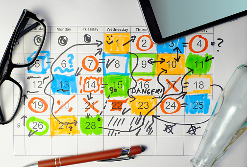 Calendar with business appointments,pens and spectacles, monthly schedule. Business concept,beat the clock.