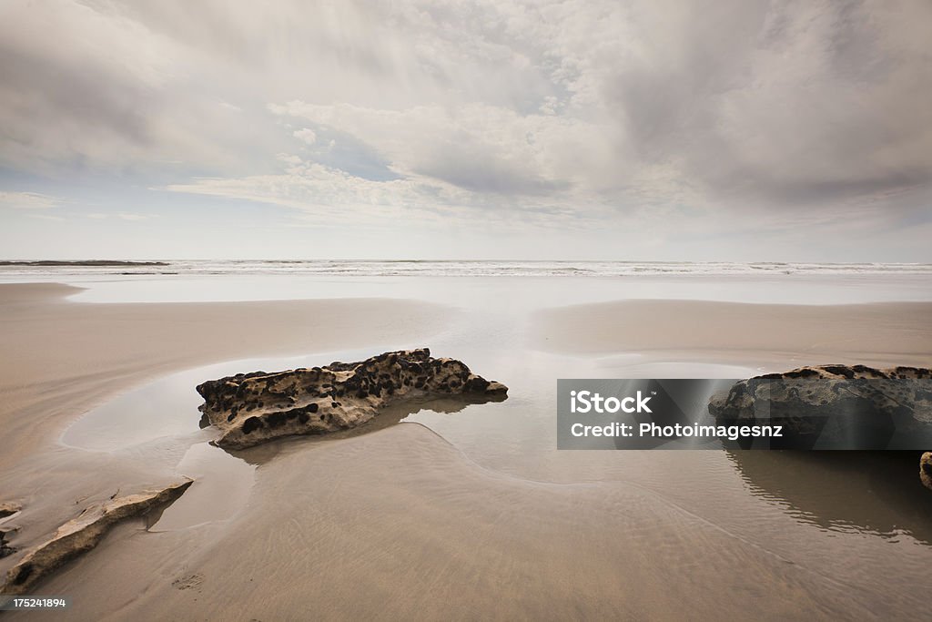 Seascape image,  North West Nelson, New Zealand "Seascape image with clouds reflecting on wet sand at low tide,  North West Nelson, New Zealand" Beach Stock Photo