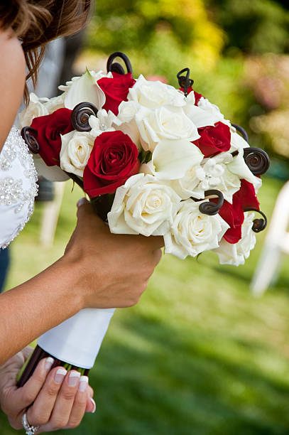 istock Bride Walking Down the Aisle Holding Rose Bouquet 175242224