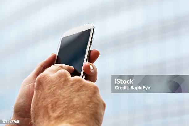 Searching For A Signal Male Hand Holds Up Smart Phone Stock Photo - Download Image Now