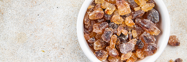 rock sugar crystals pieces candy brown sugar candied big rock caramel taste cane sugar healthy eating cooking appetizer meal food snack on the table copy space food background rustic top view
