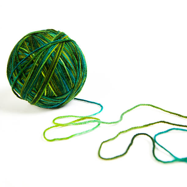Multi-colored green merino wool yarn in fingering weight.  Isolated on a white background.
