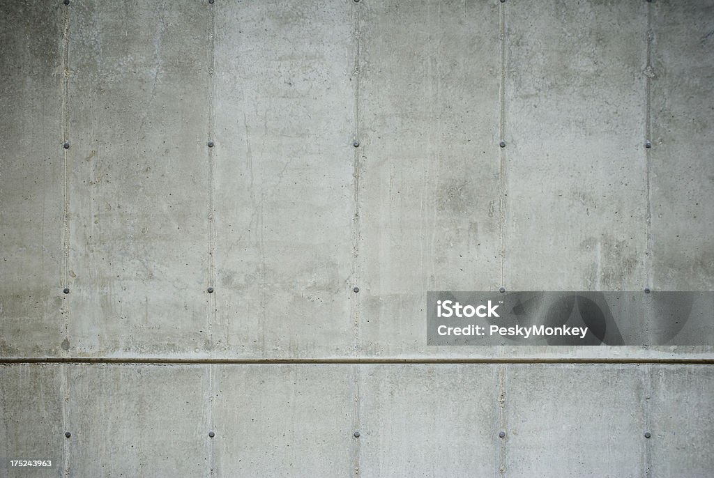 Fresh Raw Concrete Wall Full Frame Close-Up Fresh raw split level concrete wall with plugs and cracks in a full frame close-up Abstract Stock Photo