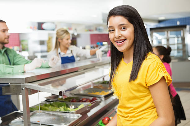 istock Middle school students choosing healthy lunch items in cafeteria line 175244174