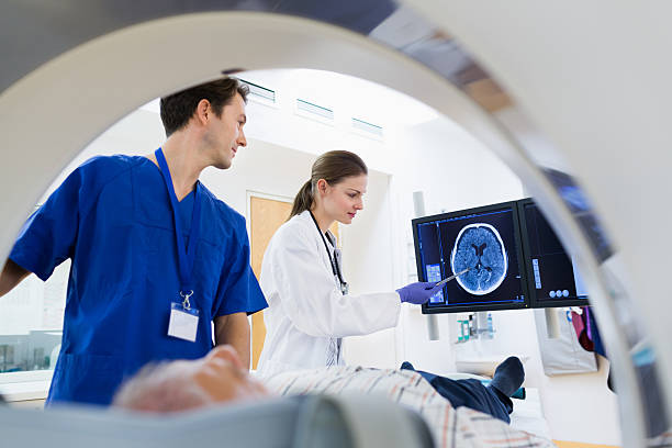 Two Doctors with Patient at CAT Scan stock photo
