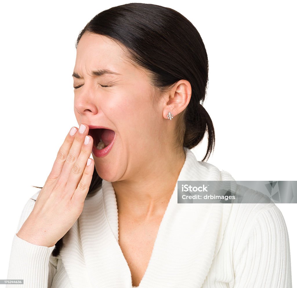 Yawning Woman Portrait of a woman on a white background.  20-29 Years Stock Photo