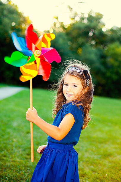 istock Happy girl with a pinwheel 175244826