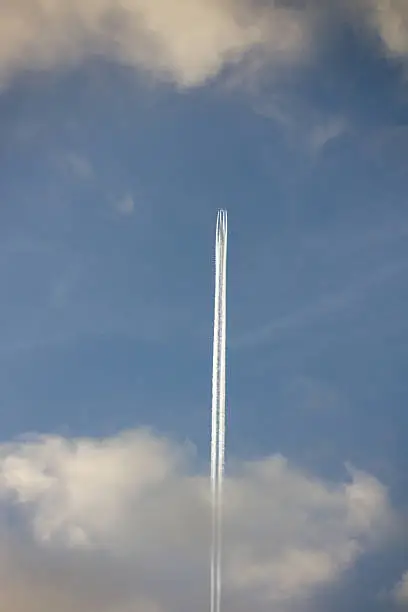 Closeup on airplane contrail against clear blue sky