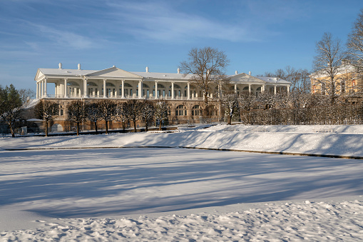View of the Cameron Gallery on the shore of the Mirror Pond in the Catherine Park of Tsarskoye Selo on a sunny winter day, Pushkin, St. Petersburg, Russia