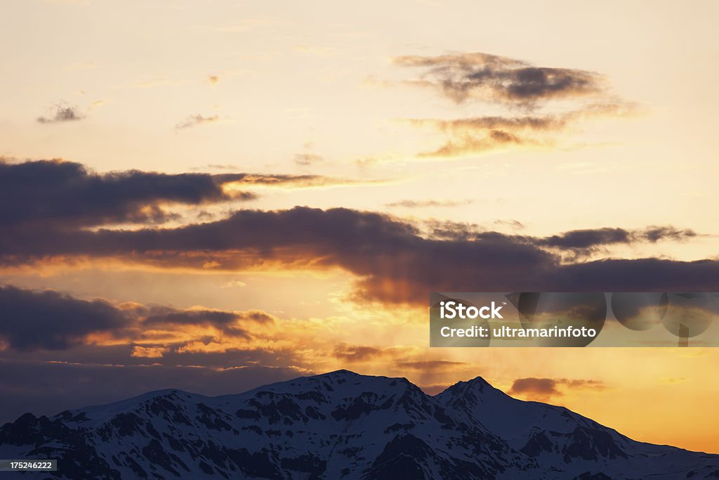 Fresh snow on the top of Alps Mountains "Sunrise, morning dawn. First snow on the top of Alps Mountains. Panoramic view of  high mountain landscape. Ski area. European Alps. The grain and texture added." Cloud - Sky Stock Photo