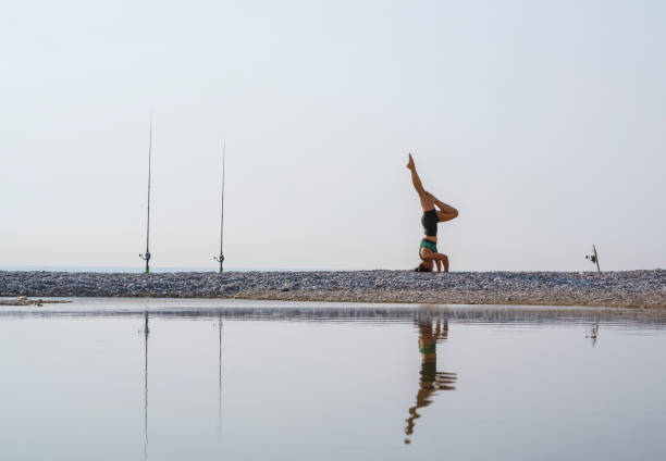 A young black woman with short hair practicing yoga outdoors