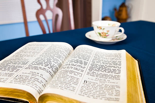 istock Open Bible on kitchen table with coffee cup and saucer 175246712